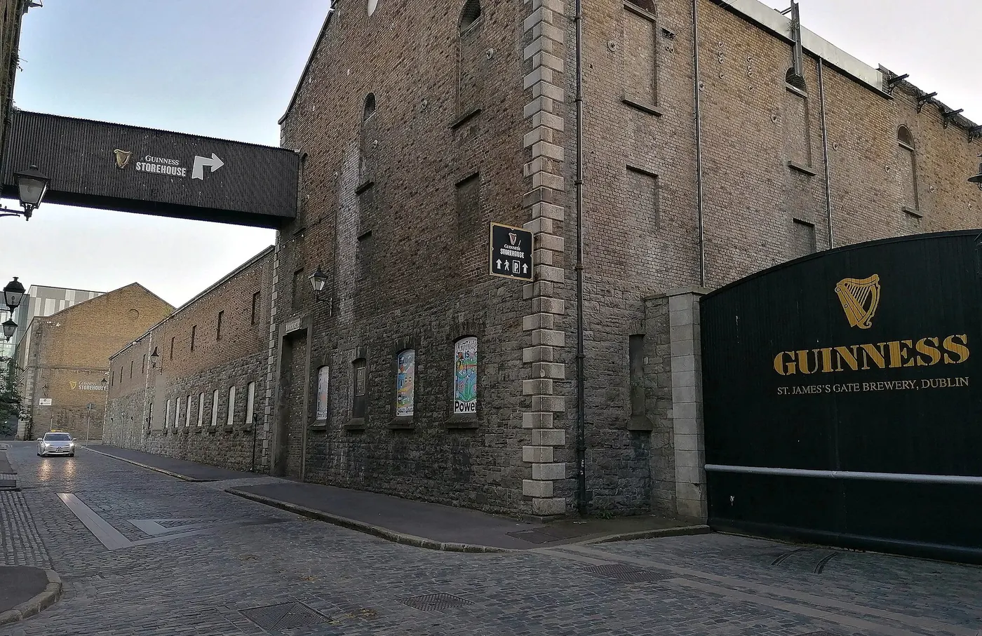 The stone wall and dark green gate of the Guinness Brewery at St James's Gate in Dublin